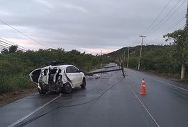 Carro derrapa na estrada molhada e derruba dois postes na AL-101 Norte