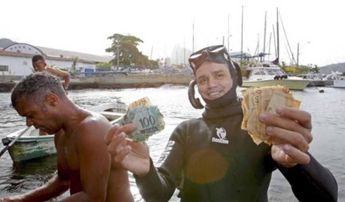 Caça ao tesouro: pescadores se empenham na busca por cédulas na orla do RJ